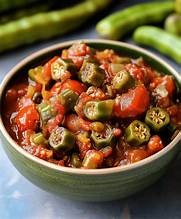 Cast iron skillet filled with tender okra and stewed tomatoes
