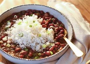 Bowl of creamy vegan red beans and rice with herbs and spices