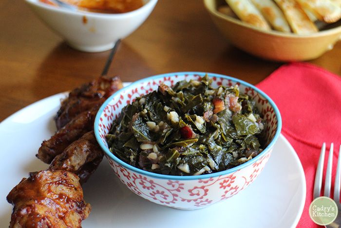 Bowl of smoky vegan collard greens with deep color and rich texture